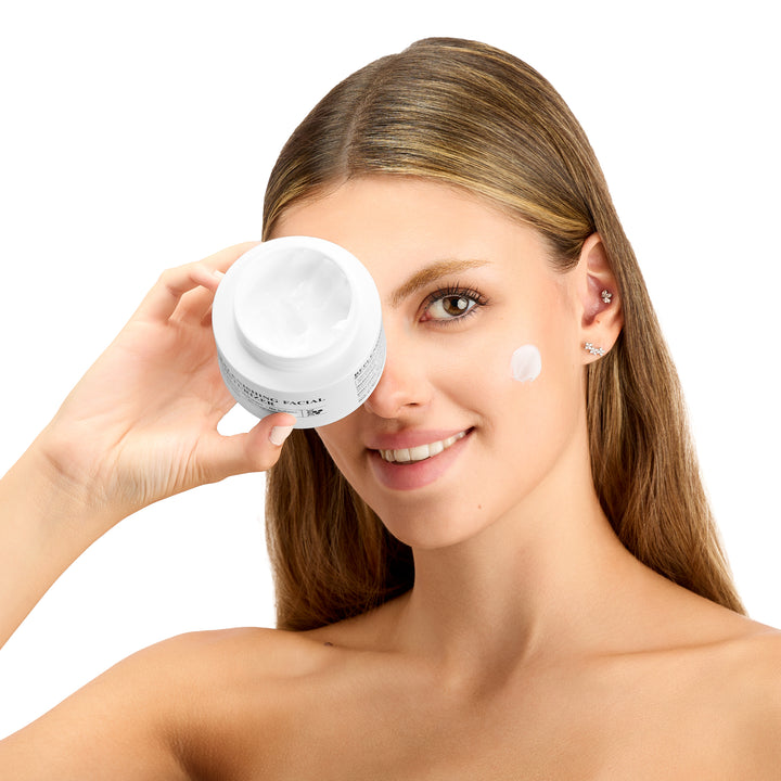 Curv Skin Replenishing Facial Moisturizer bottle being held over face.